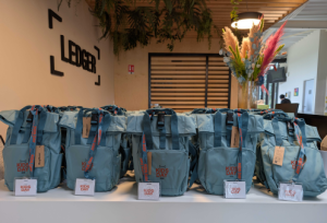 Gift bags on a table for the Ledger kids day